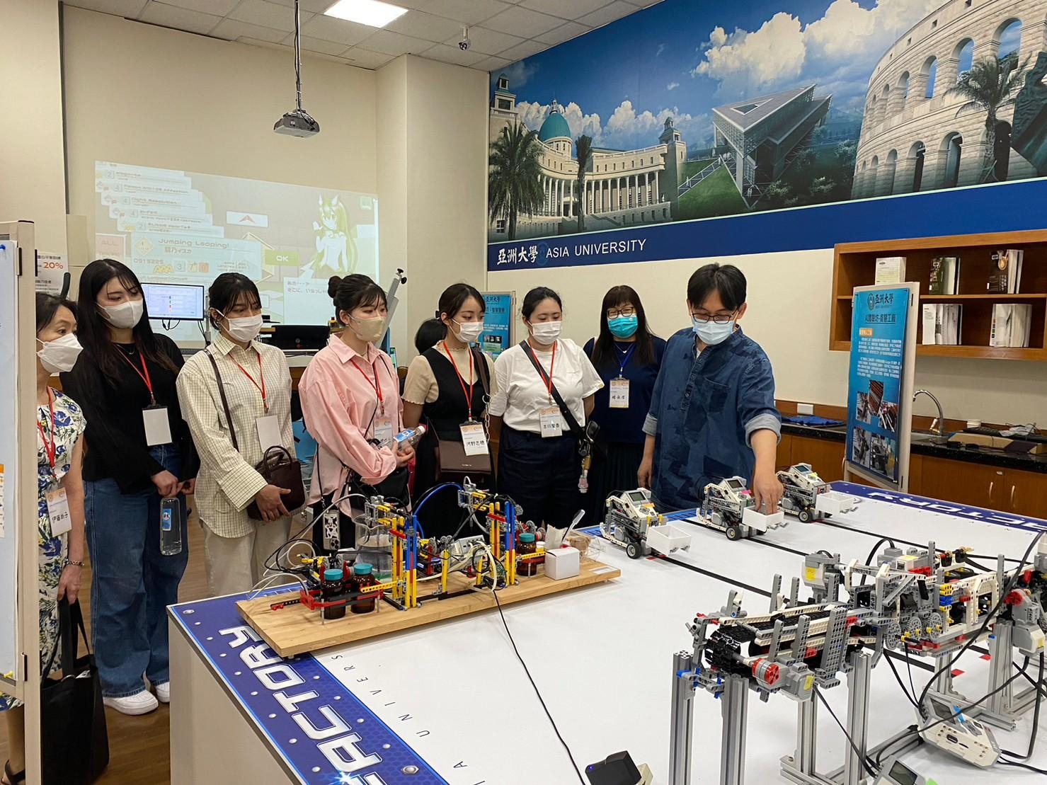 圖說：日本國際關西大學師生由亞大圖書館人員英文導覽AI練功坊，開心體驗智慧生活。